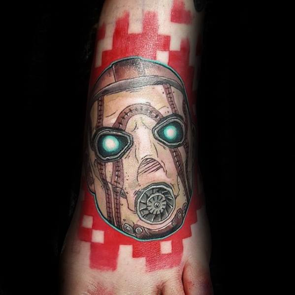 Psycho Bandit mask tattoo with glowing teal eyes, surrounded by a bold red pixel-style background for a modern, digital twist.