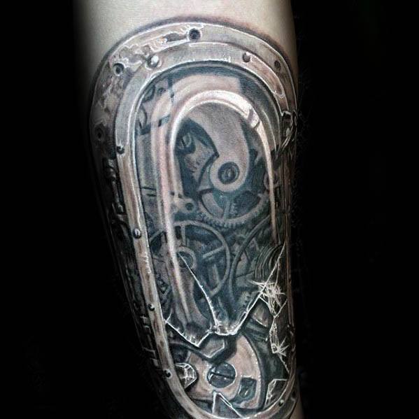 Realistic biomechanical tattoo of a watch mechanism under cracked glass, revealing gears and metal parts beneath the skin for a cyborg look.