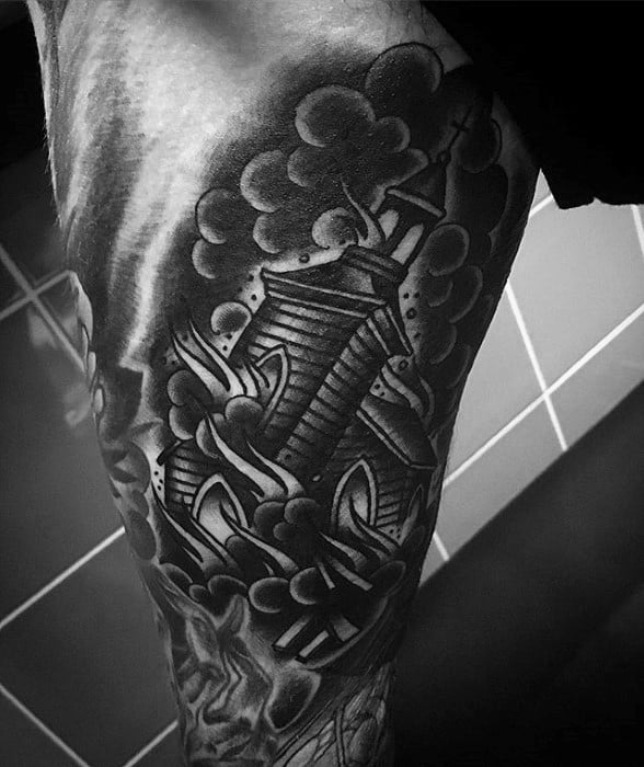 Black and grey tattoo of a burning wooden church with bold smoke clouds and stylized flames. Placed on the upper leg with dynamic shading.