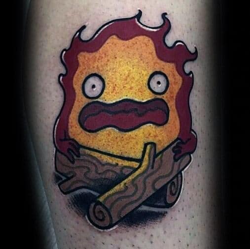Bold Calcifer tattoo with deep red flames, holding crossed logs, and a shocked expression with wide eyes and a wavy mouth.