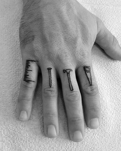 Minimalist finger tattoos featuring a ruler, nail, hammer, and chisel, symbolizing craftsmanship, precision, and a passion for woodworking.