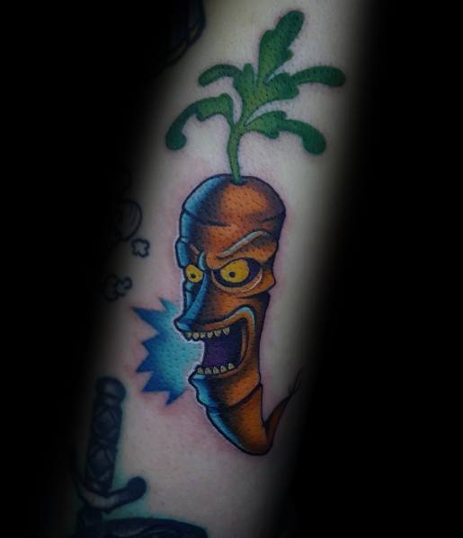 Bold and colorful tattoo of an animated evil carrot with intense shading, sharp teeth, and glowing eyes for a dynamic and edgy design.
