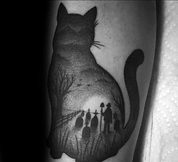 Dark and eerie blackwork cat tattoo featuring a graveyard scene within its silhouette, creating a haunting and mysterious design.