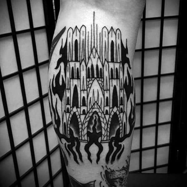 Bold blackwork tattoo of a gothic cathedral surrounded by stylized flames and dripping shapes, blending architecture with abstract elements.