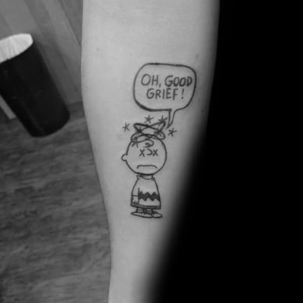 Minimalist black and white Charlie Brown tattoo with a dizzy expression and 'Oh, Good Grief!' speech bubble, capturing classic Peanuts humor.