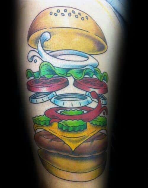 Tattoo of a deconstructed cheeseburger with bun, lettuce, onions, cheese, pickles, tomato, and patty