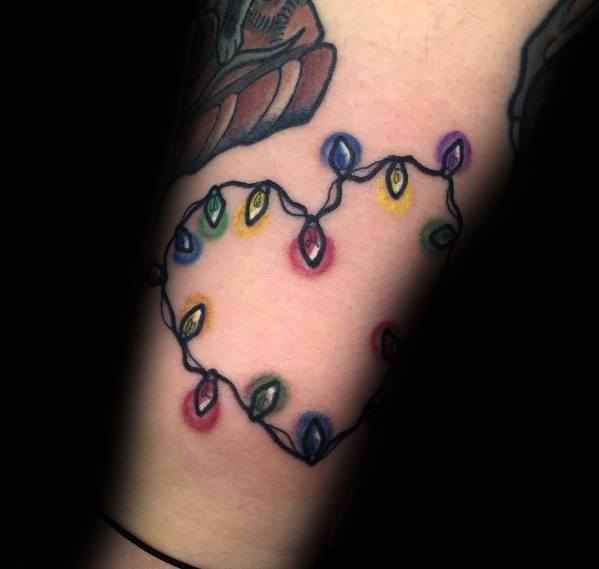 Christmas tattoo of colorful holiday lights arranged in the shape of a heart, blending festive cheer with a simple and meaningful design.