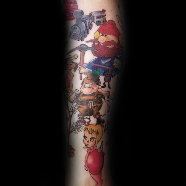 Christmas tattoo featuring characters from *Rudolph the Red-Nosed Reindeer*, including Yukon Cornelius, the Bumble, and Dolly, capturing a nostalgic holiday theme.
