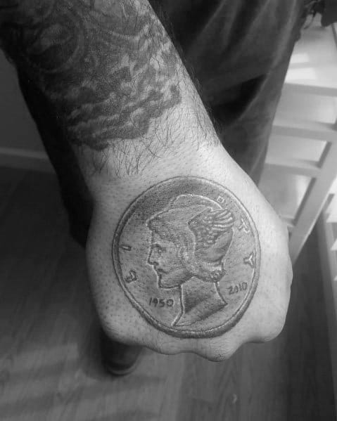 Realistic tattoo of a Mercury dime on the hand, featuring intricate shading and a personalized date for a unique, commemorative design.
