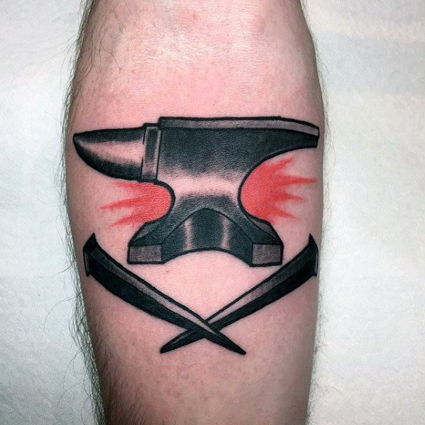 Bold anvil tattoo with red burst accents behind it and two blacksmith nails crossed beneath, creating a strong and striking forearm design.