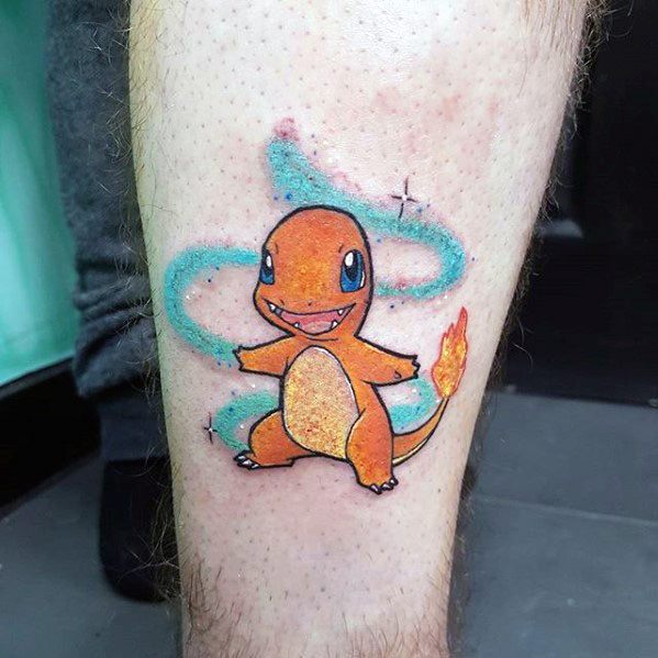 Glittery-style Charmander tattoo with sparkles and a swirling blue aura around it, giving a magical and playful vibe on the leg.