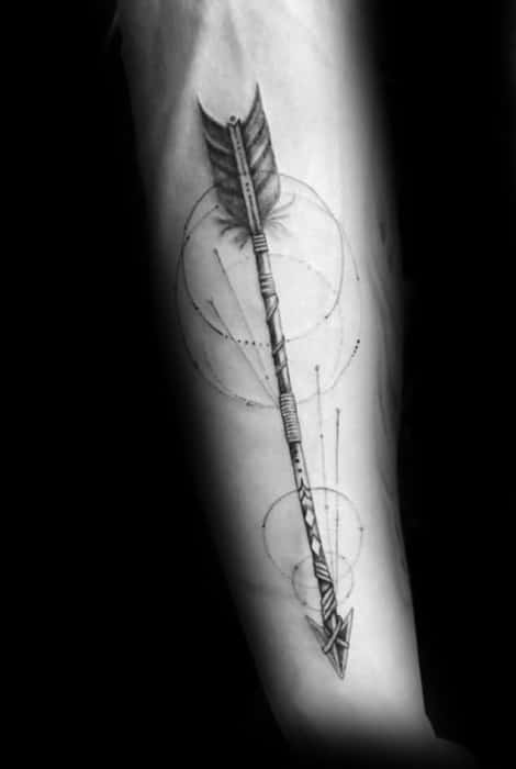 Realistic geometric arrow tattoo on the forearm with fine detailing, circular elements, and precise linework for a sleek modern look.
