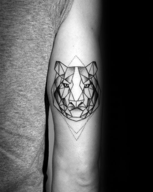 Geometric tiger head tattoo on the tricep, outlined with fine black lines and placed within a dotted diamond shape for symmetry.