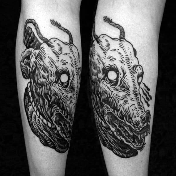 A bold, detailed tattoo featuring a stylized, eerie portrayal of a greyhound’s head, with intricate line work and surreal, hollow eyes.