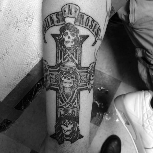 Guns N' Roses tattoo featuring skull versions of band members on a cross, with a banner reading "Guns N' Roses" above.
