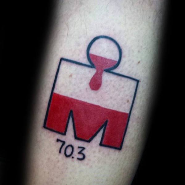 Minimalist Ironman 70.3 tattoo with a red half-filled logo and a paint-drip effect extending from the circle into the main body.