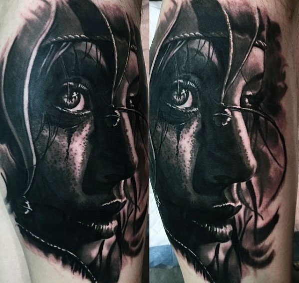 A black and gray tattoo of a detailed portrait of a woman with intricate shading, capturing her expressive eyes and delicate features, placed on the forearm.
