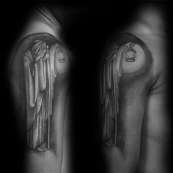 Upper arm tattoo of the hooded hermit holding a lantern, inspired by Led Zeppelin’s 'Stairway to Heaven' album artwork.