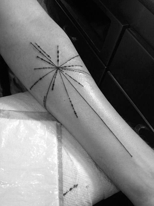 A black line and dot geometric tattoo of a pulsar map on a person's forearm