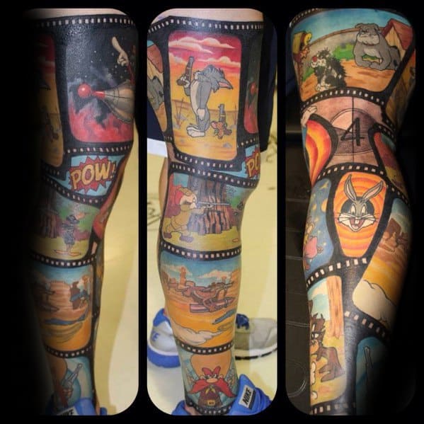 Full leg sleeve tattoo featuring Tom and Jerry and Looney Tunes characters in a vibrant film strip layout with action scenes and cartoon flair.