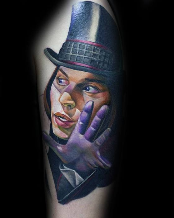 Realistic Willy Wonka tattoo with vivid colors, showing a dramatic expression, purple glove, and tall black hat.