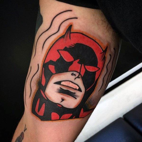 Bold neo-traditional Daredevil tattoo with thick outlines, vibrant red and black, and wavy lines suggesting his radar sense.