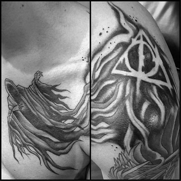 Black and grey chest and shoulder tattoo of a flowing Dementor paired with the Deathly Hallows symbol and swirling shadows.