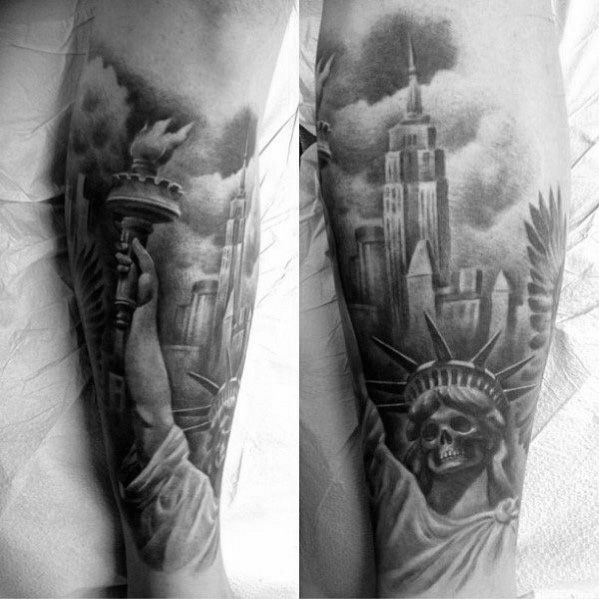 Empire State Building tattoo with a skull-faced Statue of Liberty, inked in bold black shading and striking realism on a man's forearm.