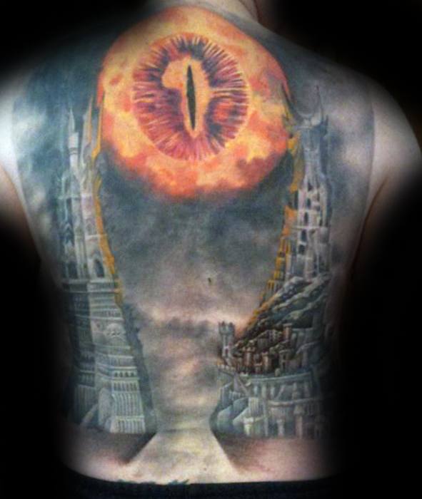 A stunning back tattoo features the ominous Eye of Sauron looming above two iconic towers from "The Lord of the Rings