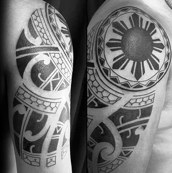 Filipino sun tattoo on the shoulder with bold black rays, circular tribal border, and swirling Polynesian-inspired patterns on the upper arm.