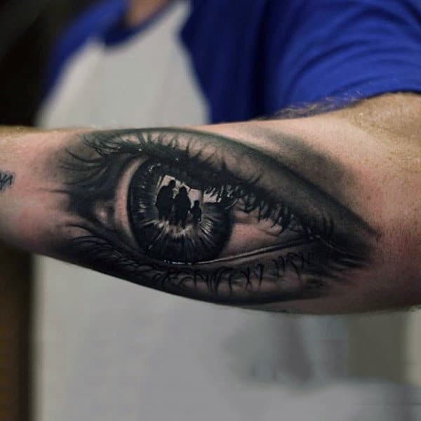 Male Forearm Three People Inside Eye Ball Tattoo