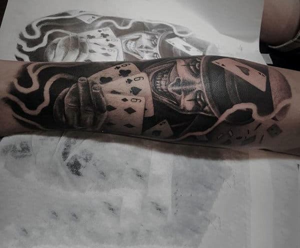 Male Forearms Gleeing Man With Playing Cards Tattooo
