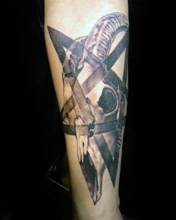 Tattoo of a ram skull intertwined with a pentagram on a forearm