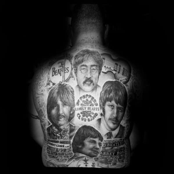 Full-back tattoo tribute to The Beatles featuring realistic portraits, "Sgt. Pepper's" emblem, musical notes, and references to Abbey Road and Penny Lane.