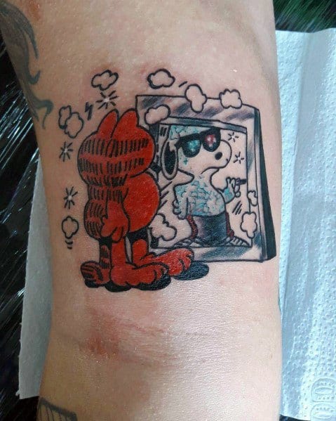 Garfield tattoo looking into a mirror reflecting Snoopy in sunglasses—a fun and creative crossover design with a playful twist.