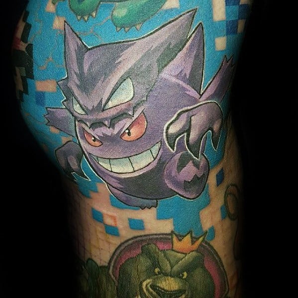 Gengar tattoo in a dynamic pose over a pixelated blue background, blending video game aesthetics with bold cartoon-style energy.