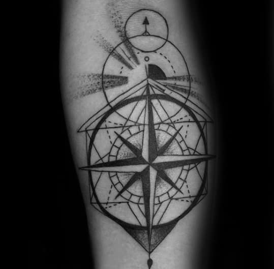 Abstract compass tattoo on forearm with bold lines, layered circles, and shaded geometry, blending direction with modern design.