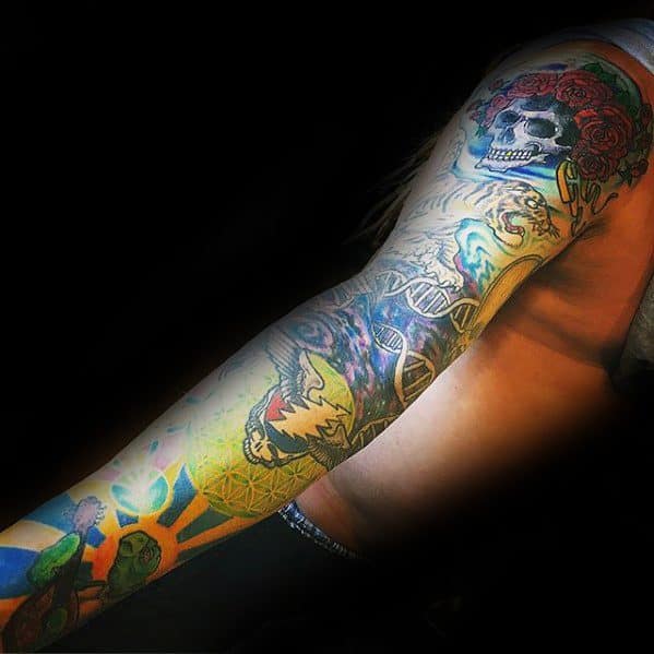 Full sleeve Grateful Dead tattoo with a rose-crowned skull, dancing bears, psychedelic patterns, and vibrant cosmic imagery.