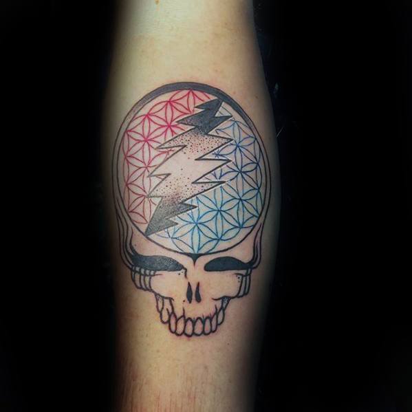 Grateful Dead Steal Your Face skull tattoo with a red and blue geometric flower of life pattern and a bold lightning bolt in the center.
