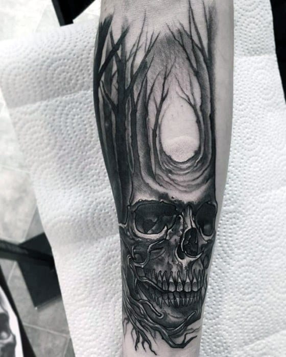 Male Great Tattoo With Skull And Row Of Trees Design On Inner Forearm