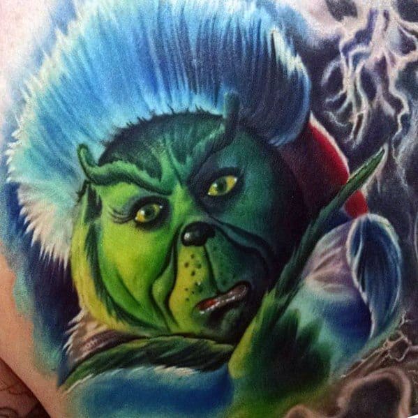 Vibrantly detailed Grinch with a blue Santa hat, showing a mischievous expression and dramatic shading, creating a colorful and dynamic tattoo design.