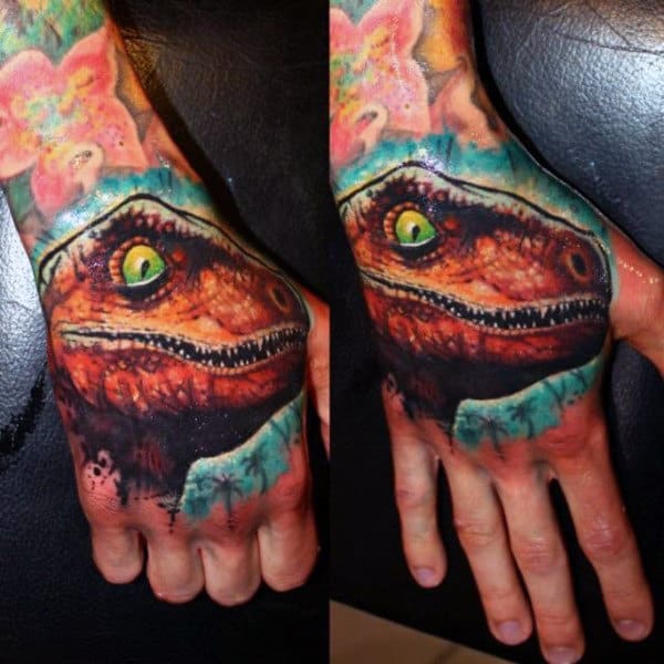 Male Hands Green Eyed Brown Dinosaur Tattoo