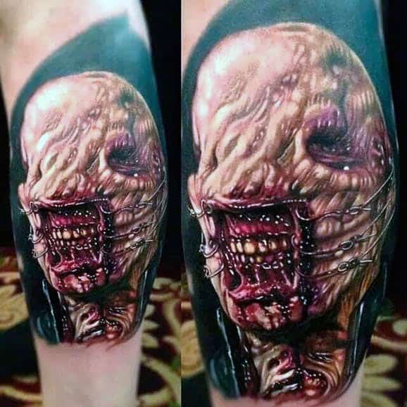 Hyper-realistic *Hellraiser* tattoo of a grotesque Cenobite with exposed flesh, stitched mouth, and deep red tones for a terrifying horror effect.