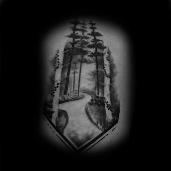 This tattoo features a serene forest path framed within a geometric shape, symbolizing a journey through nature, peace, and exploration.