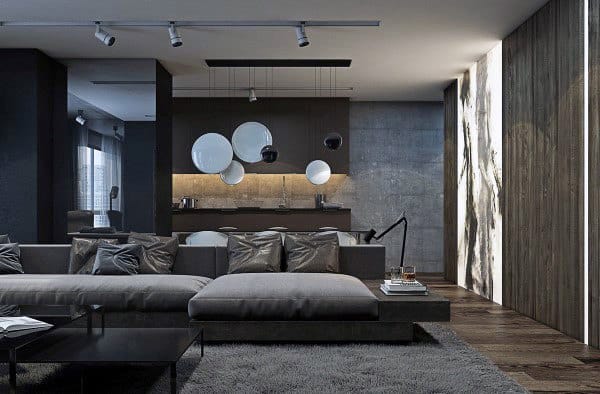 Sleek modern living room with gray sectional, wooden accents, and pendant lighting.