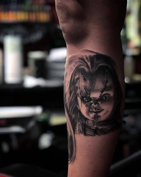 Black and grey tattoo of Tiffany from *Bride of Chucky*, featuring her stitched face, intense shading, and eerie details for a haunting horror design.