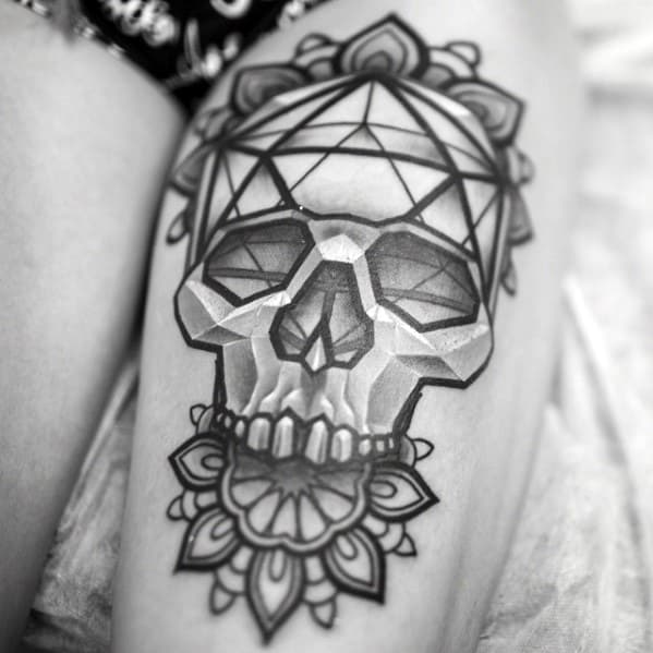 Geometric skull tattoo with an icosahedron crown and mandala-style floral accents, blending symmetry, depth, and bold shading.