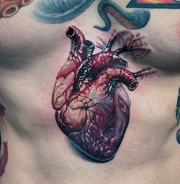 Hyper-realistic chest tattoo of a human heart with vivid red and purple tones, detailed veins, and 3D shading for lifelike depth.