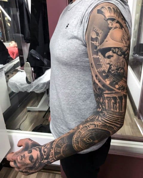Black and grey full-sleeve tattoo featuring detailed Roman and Greek warrior statues, intricate clockwork elements, and dramatic shading for a timeless design.