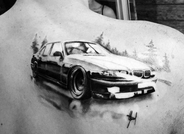 Realistic BMW drifting tattoo on upper back, featuring bold shading and motion effects for a dynamic and high-performance design.